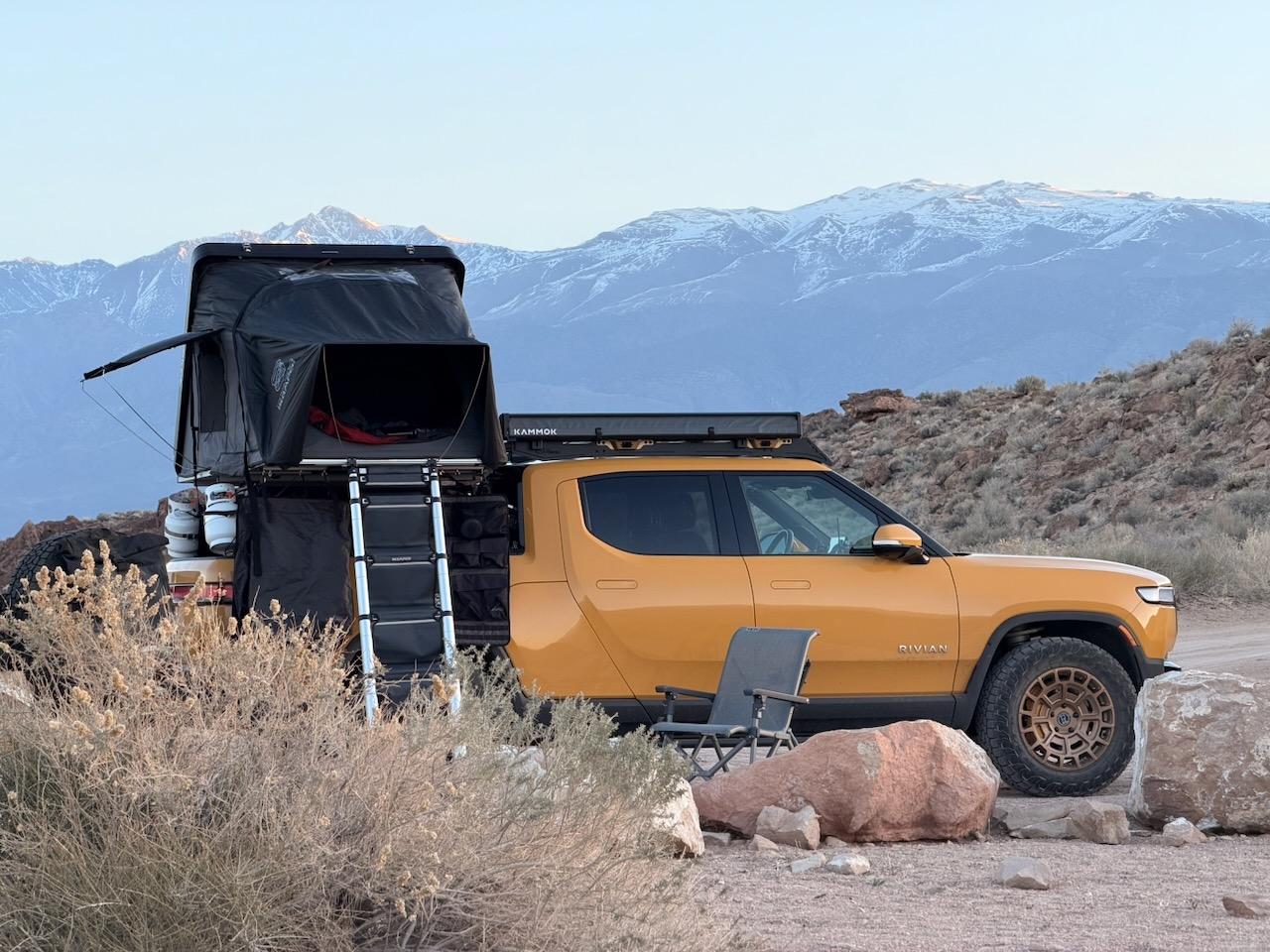 Rivian R1T parked at an off-road campsite in the desert