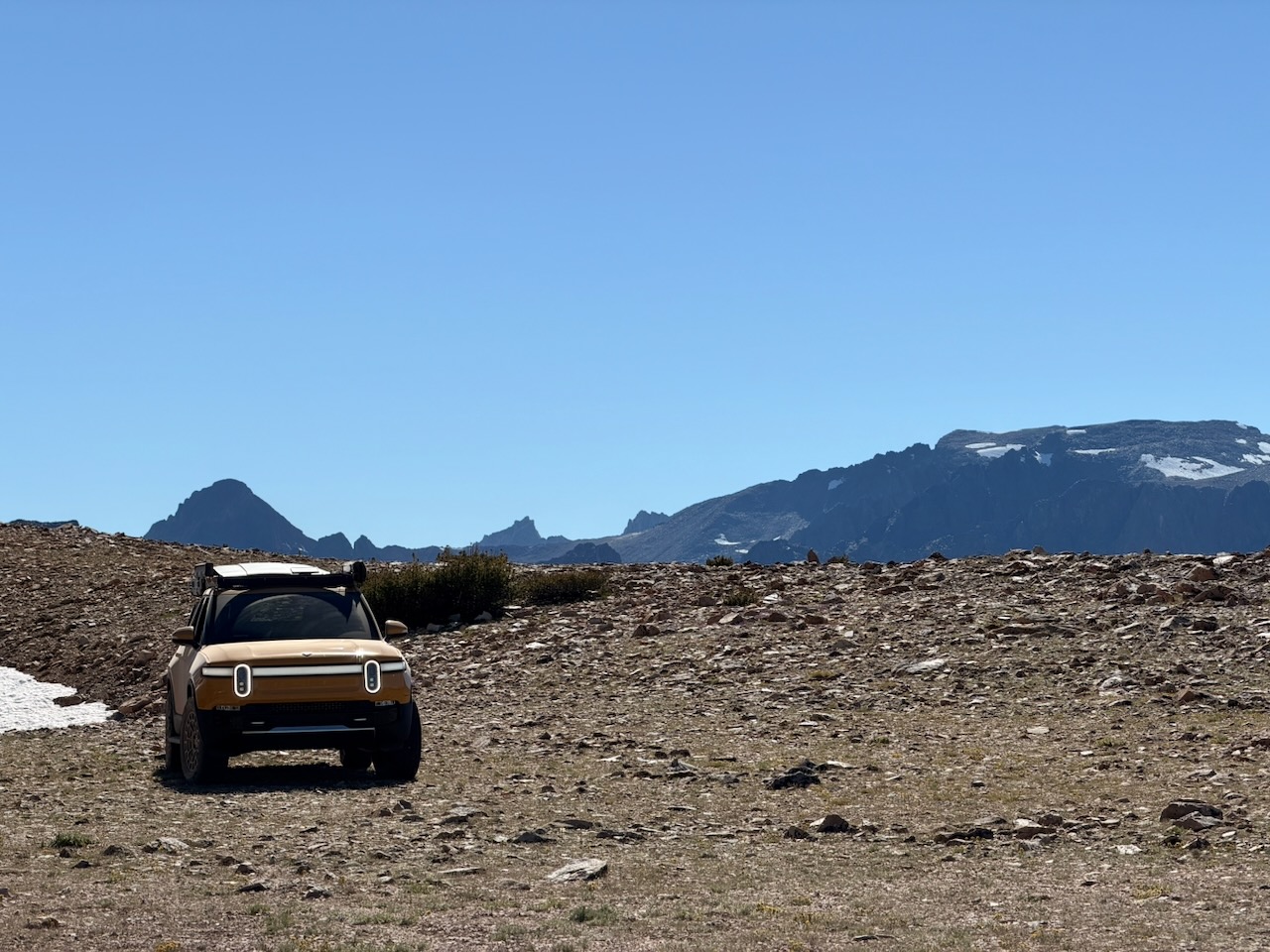 Rivian parked at a remote campsite