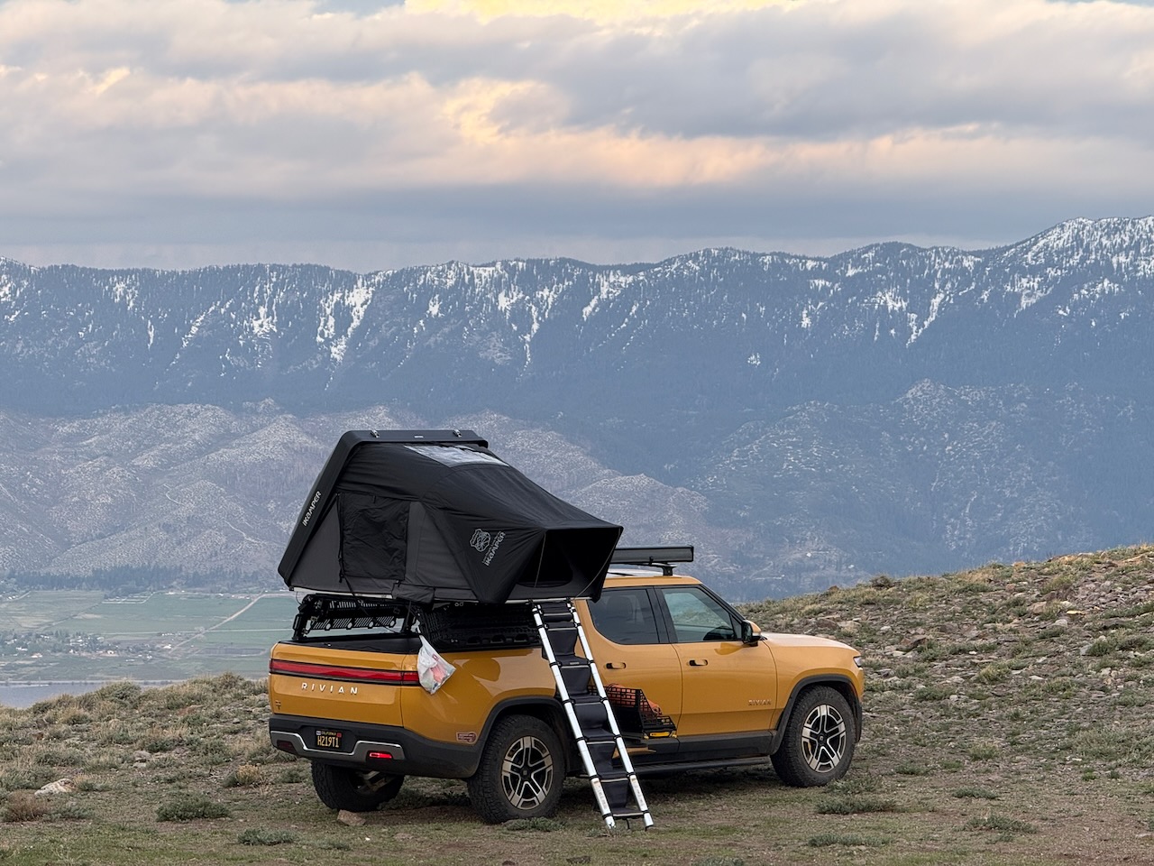 Rooftop tent open on the Rivian at camp